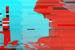 hooded computer hacker working on desktop pc P9UKKRA e1580421669550